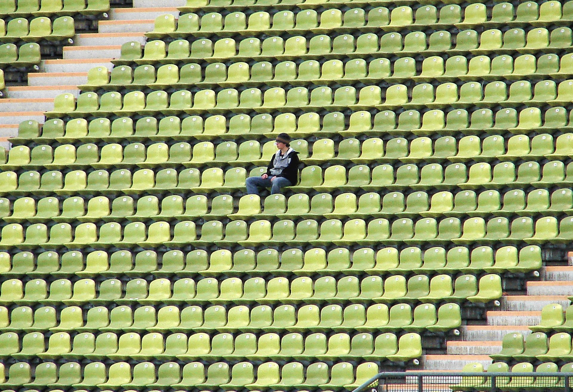 Photograph of a man alone in a stadium