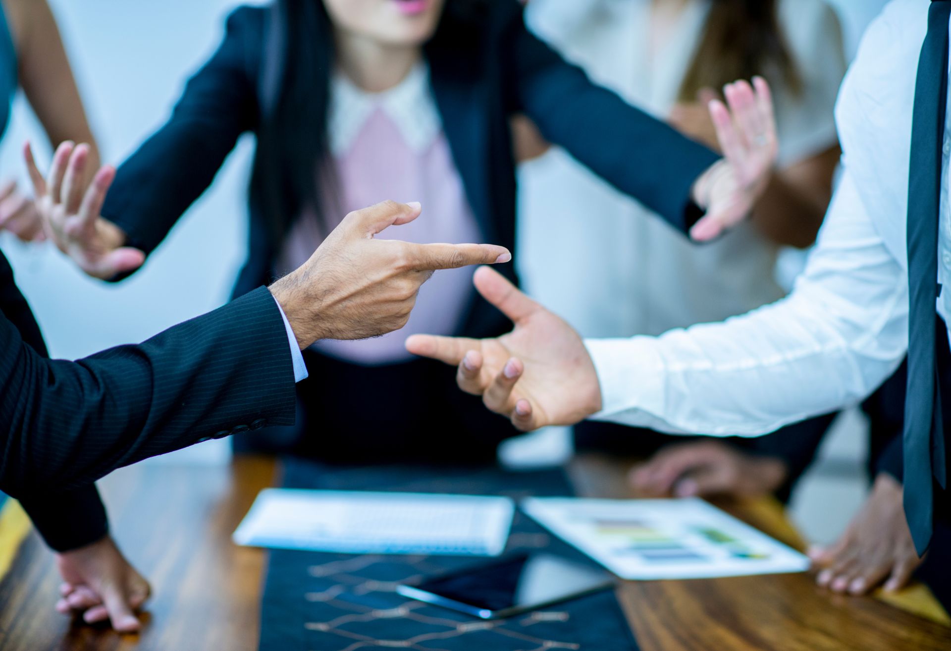 Image of person preventing two people arguing