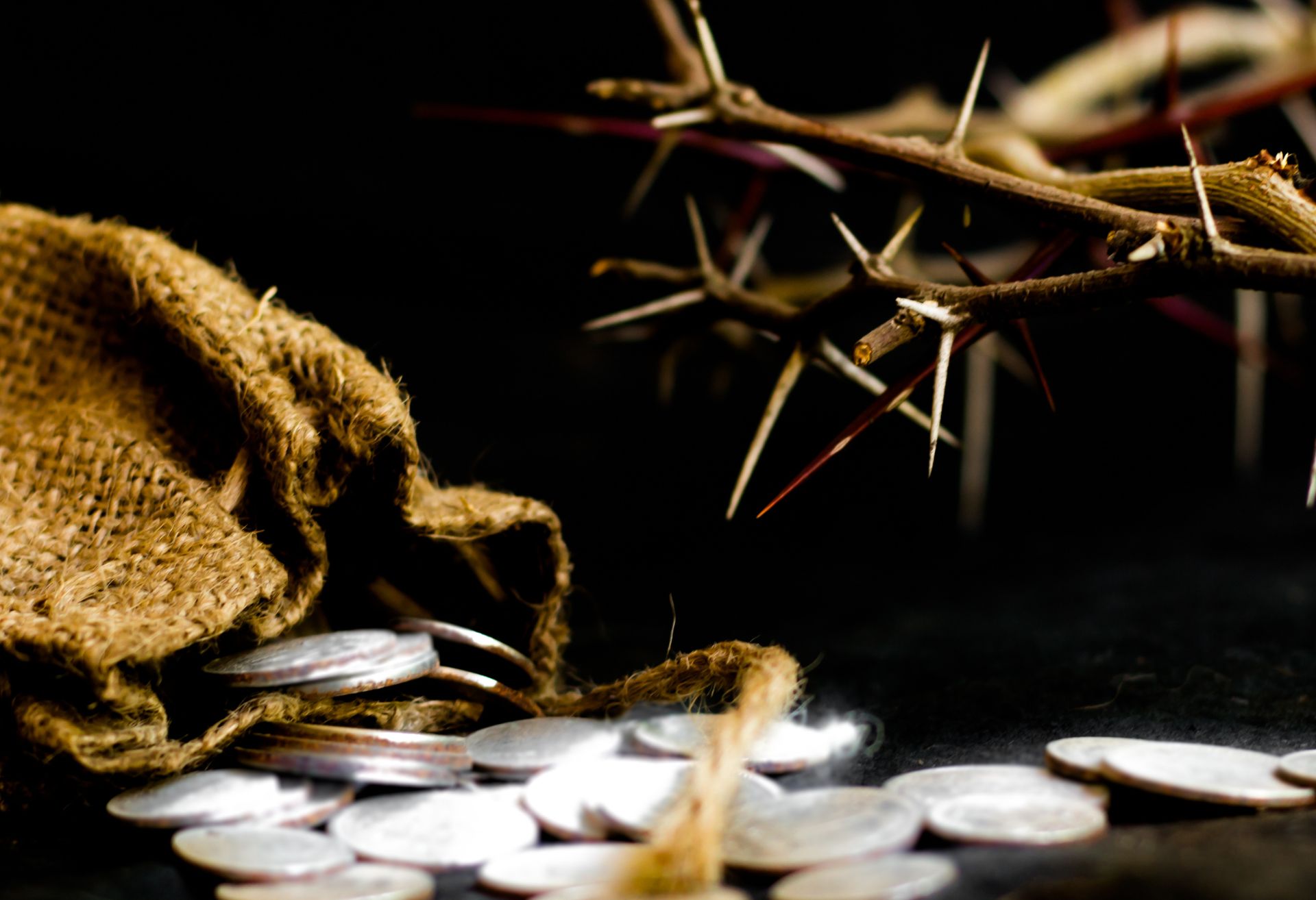 Image of sliver coins and a crown of thorns