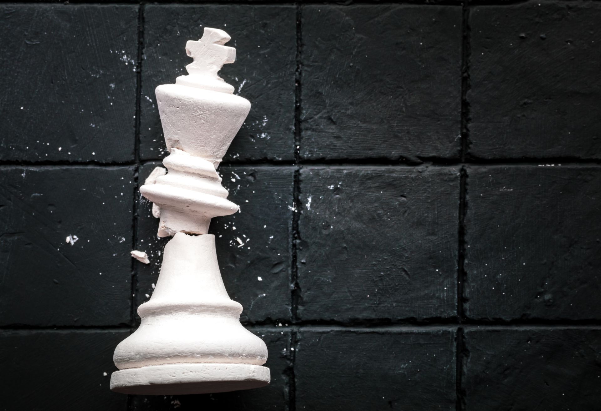 White chess King broken on the floor