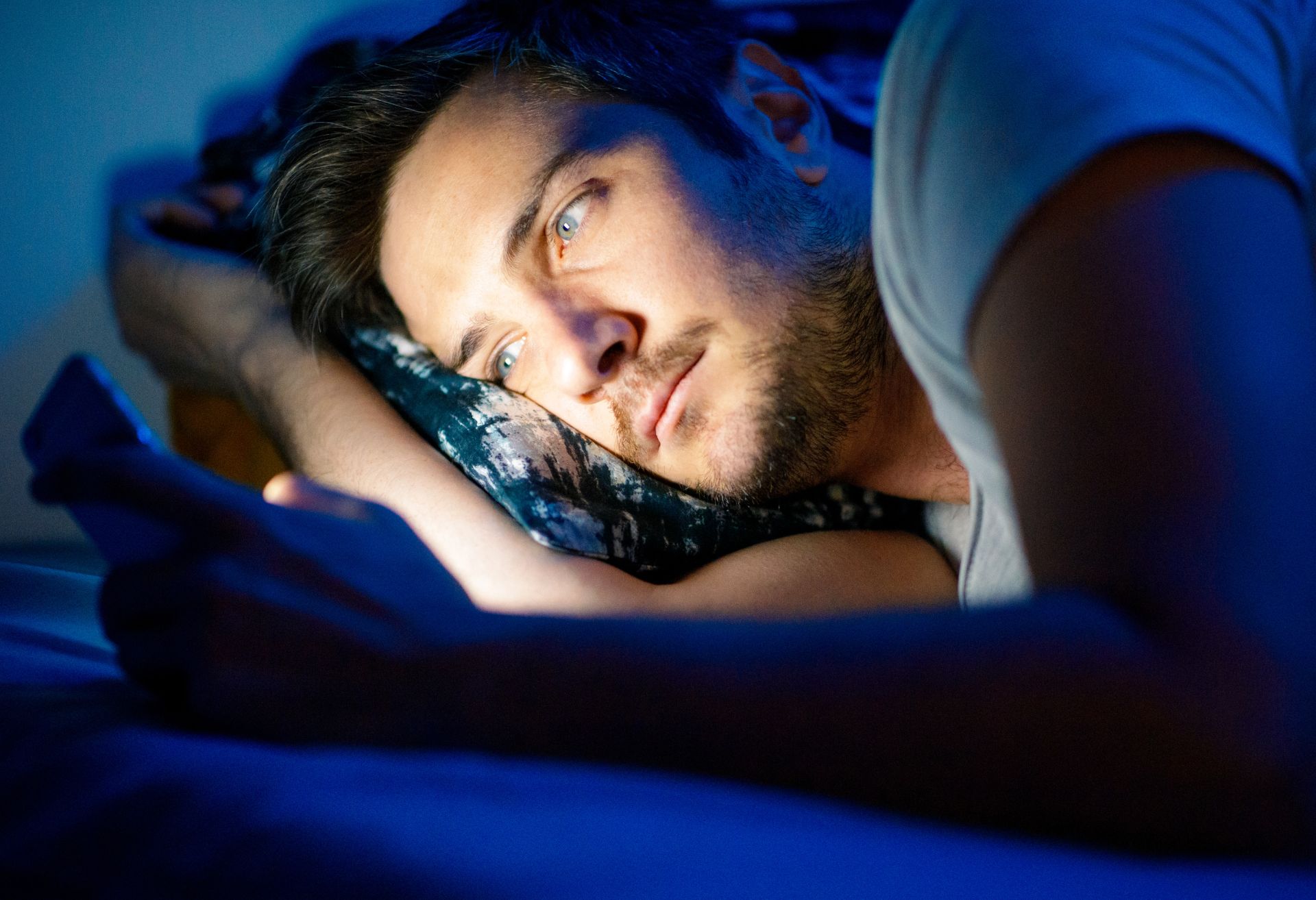 Man on phone in bed