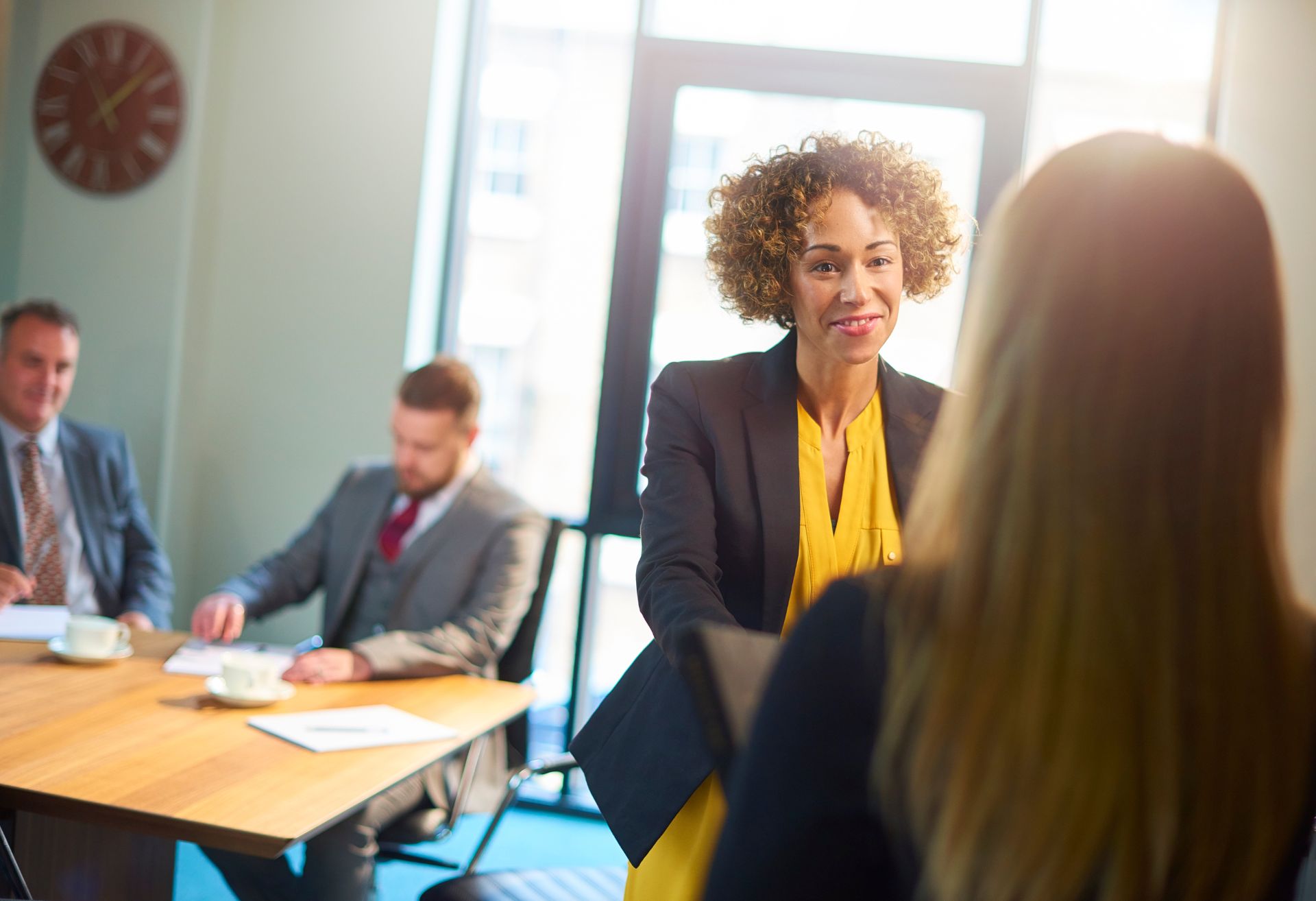 Image of an interviewer welcoming an interviewee to the interview room