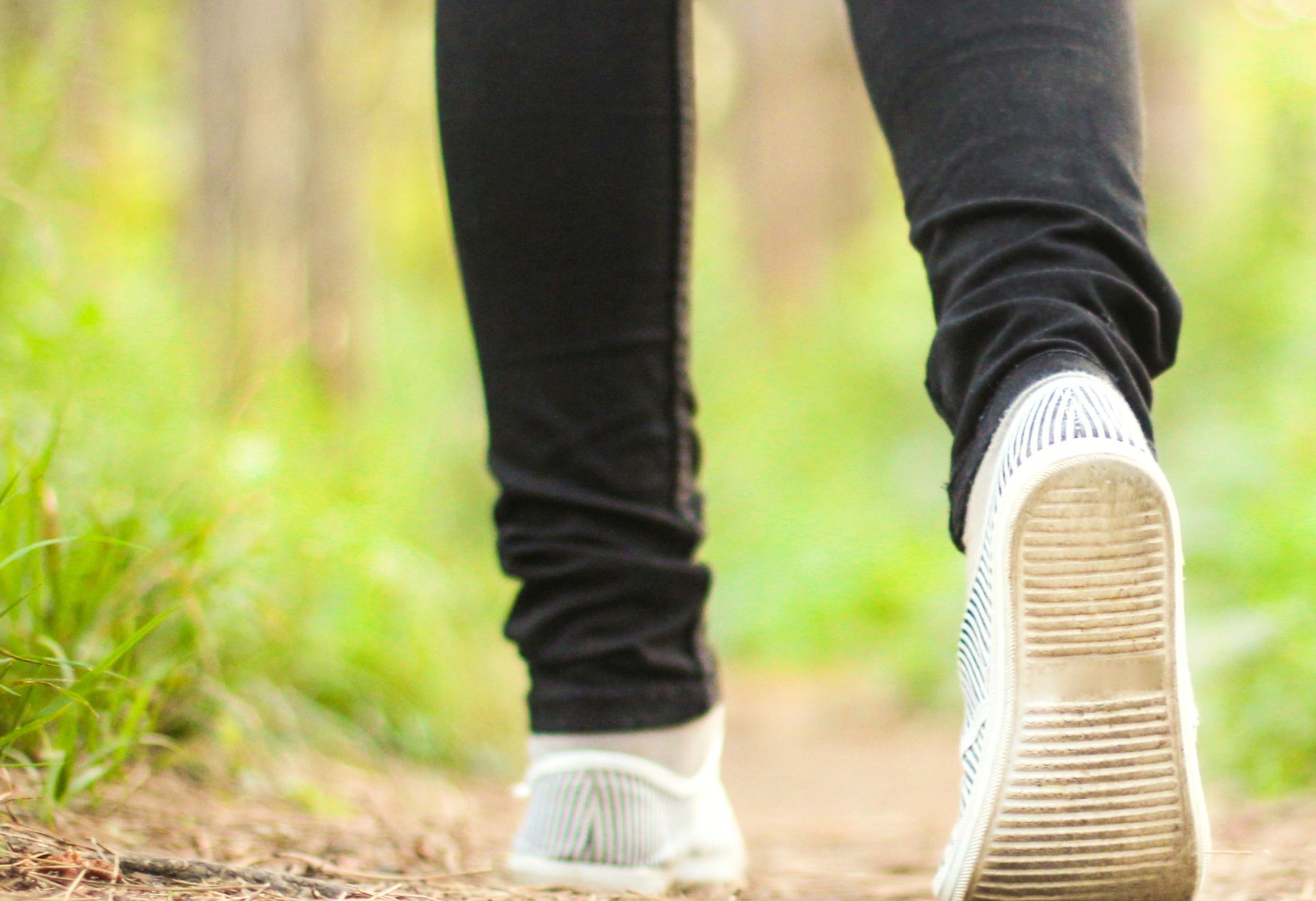 Photograph of feet walking along a path outdoors