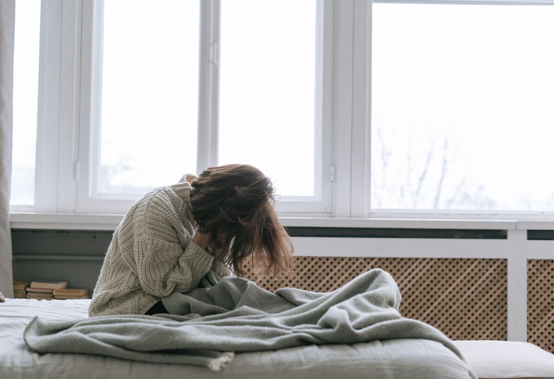 Woman in bed showing pain